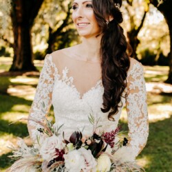 Bride Holding Feathery & Flower Arrangement