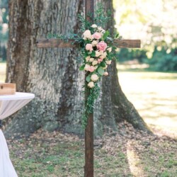 Floral arrangement on a wooden cross